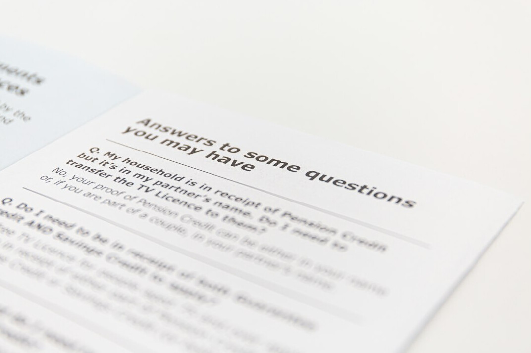 Close-up of a printed survey questionnaire with a pen and statistical charts on a desk
