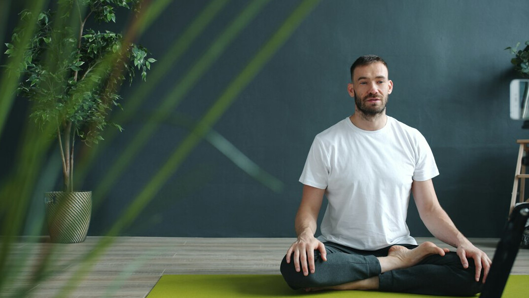 person meditating at home